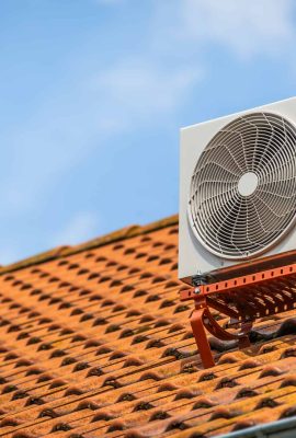 Dual inverter, combination of air conditioner compressor and heating pump, installed on a roof of family house.