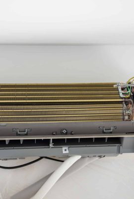 Installation air conditioning system on white wall in apartment, office closeup. Technology inverter air conditioning system in apartment. Ventilation replacement in house. Controlling temperature