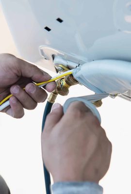 vecteezy_man-is-installing-wall-compressor-of-air-conditioner-during_9299852-scaled.jpg